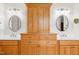 Bathroom featuring double sinks, a central cabinet, and elegant fixtures for a luxurious experience at 77 Ruffed Grouse, Chapel Hill, NC 27517