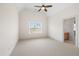Bright bedroom featuring neutral carpet, ceiling fan, and ample natural light at 77 Ruffed Grouse, Chapel Hill, NC 27517