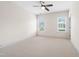 Neutral bedroom with plush carpeting, ceiling fan, and bright windows at 77 Ruffed Grouse, Chapel Hill, NC 27517