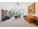 Spacious bonus room with a comfortable couch and bright windows, perfect for relaxation or activities at 77 Ruffed Grouse, Chapel Hill, NC 27517