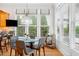 Bright dining area shows a round glass table and chairs near large windows, showcasing the outdoors at 77 Ruffed Grouse, Chapel Hill, NC 27517