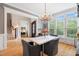 Elegant dining room with marble table, chandelier, large window, and hardwood floors at 77 Ruffed Grouse, Chapel Hill, NC 27517