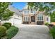 Beautiful house with stone and siding, a three-car garage, and lush greenery enhancing the property's appeal at 77 Ruffed Grouse, Chapel Hill, NC 27517
