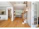 Inviting foyer with open floor plan, hardwood floors, staircase, and elegant lighting at 77 Ruffed Grouse, Chapel Hill, NC 27517