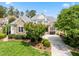 Charming stone and siding home with a well-manicured front lawn and a paved driveway leading to the entrance at 77 Ruffed Grouse, Chapel Hill, NC 27517