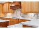 Shows a beautifully designed kitchen with custom cabinetry, modern appliances and quartz countertops at 77 Ruffed Grouse, Chapel Hill, NC 27517