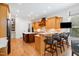 Wide angle shot of the kitchen showing the island with bar seating, and modern cabinetry and appliances at 77 Ruffed Grouse, Chapel Hill, NC 27517