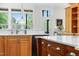 Kitchen showcasing a large island with quartz countertops, ample storage, and modern stainless steel appliances at 77 Ruffed Grouse, Chapel Hill, NC 27517