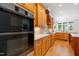 Modern kitchen features stainless steel appliances, custom cabinetry, and an open layout with hardwood floors at 77 Ruffed Grouse, Chapel Hill, NC 27517
