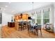 Bright kitchen features wooden cabinets, a breakfast bar with seating, and a dining area near sunlit windows at 77 Ruffed Grouse, Chapel Hill, NC 27517