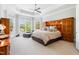 Spacious bedroom with a ceiling fan, complemented by natural light streaming through large windows at 77 Ruffed Grouse, Chapel Hill, NC 27517