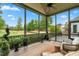 Relax on this screened-in porch with lush greenery, offering an inviting outdoor experience at 77 Ruffed Grouse, Chapel Hill, NC 27517