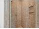 Tiled walk-in shower featuring a built-in niche and sleek fixtures at 77 Ruffed Grouse, Chapel Hill, NC 27517