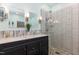Bright bathroom features a double vanity, stone-tiled shower and decorative accents at 7901 Farnham Ct, Raleigh, NC 27615