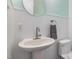 This half bathroom features modern pedestal sink, accent wall trim and recessed lighting at 7901 Farnham Ct, Raleigh, NC 27615