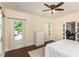 Bright bedroom with hardwood floors, a ceiling fan, and an attached space separated by sliding glass doors at 7901 Farnham Ct, Raleigh, NC 27615