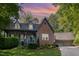 Two-story brick home with front porch and mature landscaping with a detached two-car garage at 7901 Farnham Ct, Raleigh, NC 27615