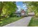 Charming home with brick facade, inviting porch, landscaped front yard, and two-car detached garage at 7901 Farnham Ct, Raleigh, NC 27615