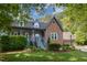 A charming brick home with a cozy front porch, well-manicured landscaping, and two-car garage at 7901 Farnham Ct, Raleigh, NC 27615