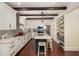 Modern kitchen with white cabinets, stainless steel appliances, island with seating, and hardwood floors at 7901 Farnham Ct, Raleigh, NC 27615