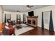 Spacious living room featuring a brick fireplace, hardwood floors, and neutral paint, perfect for relaxation at 7901 Farnham Ct, Raleigh, NC 27615