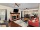 Inviting living room with brick fireplace, hardwood floors, and views of the adjacent dining area at 7901 Farnham Ct, Raleigh, NC 27615