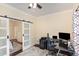 Inviting home office space with large barn doors, dark floors, and neutral walls at 7901 Farnham Ct, Raleigh, NC 27615