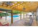 Outdoor patio area overlooking a sparkling in-ground pool and lush greenery at 7901 Farnham Ct, Raleigh, NC 27615