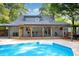 A backyard pool with an attached deck and outdoor seating offers a relaxing oasis at 7901 Farnham Ct, Raleigh, NC 27615