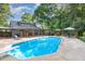 Backyard with a pool, wooden deck, dining and lounge area, ideal for outdoor entertaining at 7901 Farnham Ct, Raleigh, NC 27615