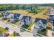 An aerial view showcases new homes lining a street with manicured lawns and mature trees at 808 Buckner Ct, Fuquay Varina, NC 27526