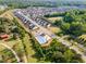 An aerial view showcases a community pool surrounded by homes and tree-lined streets at 808 Buckner Ct, Fuquay Varina, NC 27526