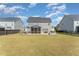 Large backyard features a patio, fire pit, and screened-in porch, enclosed by a black fence for privacy and security at 808 Buckner Ct, Fuquay Varina, NC 27526