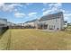 A large backyard with a patio, fire pit, screened-in porch, and a fenced perimeter, perfect for outdoor activities at 808 Buckner Ct, Fuquay Varina, NC 27526