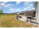 Spacious backyard featuring a stone patio, built-in seating, a fire pit and a screened-in porch for outdoor enjoyment at 808 Buckner Ct, Fuquay Varina, NC 27526