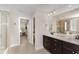 A bathroom with a double sink and entry to another room or closet at 808 Buckner Ct, Fuquay Varina, NC 27526
