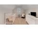 A well-lit Bedroom with a crib, dresser and a comfortable glider at 808 Buckner Ct, Fuquay Varina, NC 27526