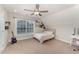 Bright bedroom with a ceiling fan and large window providing natural light at 808 Buckner Ct, Fuquay Varina, NC 27526