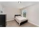 This bedroom features carpeted floors, a window and a large dresser at 808 Buckner Ct, Fuquay Varina, NC 27526
