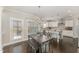 A quaint dining area features a rustic wood table, bench seating, and a window overlooking the outdoor scenery at 808 Buckner Ct, Fuquay Varina, NC 27526