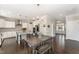 An open-concept dining area showcases a rustic table set, flowing into a kitchen with white cabinetry and an island at 808 Buckner Ct, Fuquay Varina, NC 27526