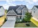 Charming two-story home with gray siding, stone accents, well-manicured lawn, and attached two-car garage at 808 Buckner Ct, Fuquay Varina, NC 27526