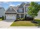 Charming two-story home with gray siding, stone accents, well-manicured lawn, and attached two-car garage at 808 Buckner Ct, Fuquay Varina, NC 27526