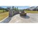 A backyard features a stone fire pit with built-in seating on a stamped concrete patio at 808 Buckner Ct, Fuquay Varina, NC 27526