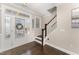 Elegant home foyer featuring hardwood floors, staircase, and glass-paneled front door, providing a welcoming entrance at 808 Buckner Ct, Fuquay Varina, NC 27526