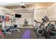 Garage gym with weight training equipment, cardio machines, and a TV for workout entertainment at 808 Buckner Ct, Fuquay Varina, NC 27526