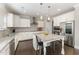 Bright kitchen boasts stainless steel appliances, white cabinetry, granite countertops, and a central island with bar seating at 808 Buckner Ct, Fuquay Varina, NC 27526