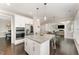 Modern kitchen with stainless steel appliances, granite countertops, white cabinets, and stylish island at 808 Buckner Ct, Fuquay Varina, NC 27526