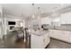 Well-lit kitchen featuring stainless steel appliances, granite countertops, a central island, and a view of the living and dining areas at 808 Buckner Ct, Fuquay Varina, NC 27526