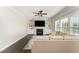 Bright living room featuring a cozy fireplace, built-in shelving, hardwood floors, and natural lighting at 808 Buckner Ct, Fuquay Varina, NC 27526